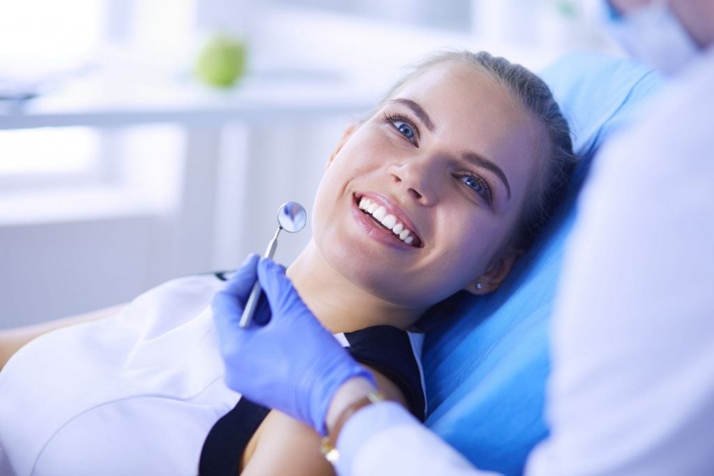 a woman lays in a dental chair