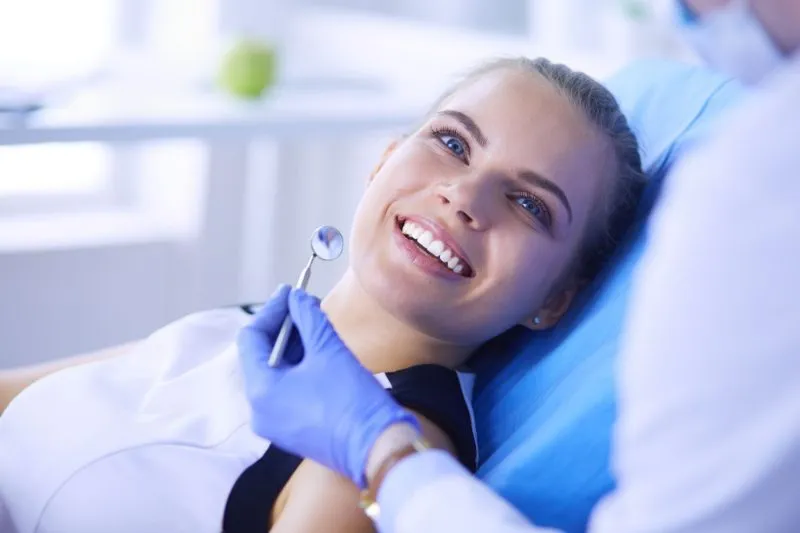 a woman lays in a dental chair